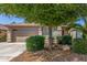 Charming single-Gathering home featuring well-manicured landscaping, a two-car garage, and a cozy front porch at 44158 W Canyon Creek Dr, Maricopa, AZ 85139