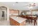 Large kitchen island offers breakfast bar seating and extra workspace, great for entertaining at 44158 W Canyon Creek Dr, Maricopa, AZ 85139