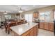 Open concept kitchen features a central island with barstool seating and ample counter space at 44158 W Canyon Creek Dr, Maricopa, AZ 85139