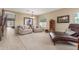 Well-lit living room with neutral tones, tile floors, and stylish furniture at 44158 W Canyon Creek Dr, Maricopa, AZ 85139