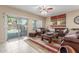 Cozy living room with sliding door to the pool, stylish furniture, and a ceiling fan at 44158 W Canyon Creek Dr, Maricopa, AZ 85139