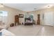 Well-lit living room with neutral tones, tile floors, and stylish furniture at 44158 W Canyon Creek Dr, Maricopa, AZ 85139