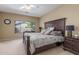 Main bedroom with decorative headboard, neutral walls, carpeted floors and lots of natural light at 44158 W Canyon Creek Dr, Maricopa, AZ 85139