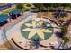 Aerial view of a recreation area with a playground, a picnic area, and lounge chairs surrounding the play area at 44158 W Canyon Creek Dr, Maricopa, AZ 85139