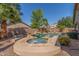 Luxurious pool and spa area surrounded by lush landscaping, creating a private and relaxing backyard retreat at 44158 W Canyon Creek Dr, Maricopa, AZ 85139