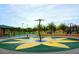 Community splash pad featuring a modern flower design, water features, and mature landscape at 44158 W Canyon Creek Dr, Maricopa, AZ 85139