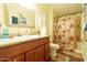 Bathroom featuring granite countertops, a wood vanity, and a shower/tub combo with curtain at 501 E Ray Rd # 36, Chandler, AZ 85225