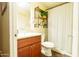 Well-lit bathroom featuring granite counters, wood cabinets, and a shower/tub combo at 501 E Ray Rd # 36, Chandler, AZ 85225