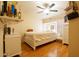 Cozy bedroom with a ceiling fan, wood floors, a bed with decorative pillows, and ample lighting at 501 E Ray Rd # 36, Chandler, AZ 85225