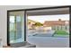 View of backyard through sliding glass door featuring pool and custom stone waterfall at 5103 E Juniper Ave, Scottsdale, AZ 85254