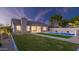 Manicured lawn and inground pool in the back of the home, perfect for outdoor enjoyment at 5103 E Juniper Ave, Scottsdale, AZ 85254