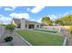 Expansive backyard features a pool, lush green grass, gravel landscaping, and a covered patio at 5103 E Juniper Ave, Scottsdale, AZ 85254