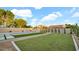 The backyard features a pristine pool, well-maintained lawn, and stylish landscaping at 5103 E Juniper Ave, Scottsdale, AZ 85254