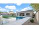 Inviting backyard with a sparkling pool, manicured lawn, and charming landscaping features at 5103 E Juniper Ave, Scottsdale, AZ 85254