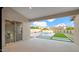 Beautiful backyard with a sparkling pool, artificial grass, and a covered patio at 5103 E Juniper Ave, Scottsdale, AZ 85254