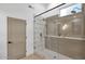 Modern bathroom with a glass-enclosed shower featuring a rainfall shower head at 5103 E Juniper Ave, Scottsdale, AZ 85254