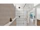 Modern bathroom with glass enclosed shower stall and beige tile at 5103 E Juniper Ave, Scottsdale, AZ 85254
