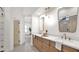 Elegant bathroom with double sinks, granite counters, and light wood cabinets at 5103 E Juniper Ave, Scottsdale, AZ 85254