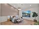 Bright primary bedroom featuring hardwood floors, modern lighting, and a textured accent wall at 5103 E Juniper Ave, Scottsdale, AZ 85254