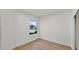 Minimalist bedroom featuring hardwood floors, window, and crisp white walls at 5103 E Juniper Ave, Scottsdale, AZ 85254