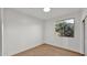 Light-filled bedroom with a large window and stylish hardwood floors at 5103 E Juniper Ave, Scottsdale, AZ 85254