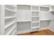 Walk-in closet with custom shelving and hardwood floors offers ample storage space at 5103 E Juniper Ave, Scottsdale, AZ 85254