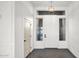 Stunning entryway with high ceilings, herringbone tile flooring, modern chandelier and ample natural light at 5103 E Juniper Ave, Scottsdale, AZ 85254