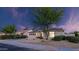 Charming single-story home featuring desert landscaping, a large shade tree, and an attached two-car garage at 5103 E Juniper Ave, Scottsdale, AZ 85254