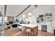 Bright, open kitchen boasts an island with seating, wooden beams, and modern finishes at 5103 E Juniper Ave, Scottsdale, AZ 85254