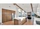 Modern kitchen showcases a large island with white countertops, stainless steel appliances, and wooden cabinets at 5103 E Juniper Ave, Scottsdale, AZ 85254