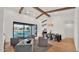 Open-concept living area with vaulted ceilings, exposed wooden beams, and oversized sliding glass door at 5103 E Juniper Ave, Scottsdale, AZ 85254