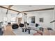 Open-concept living area with modern furnishings, wooden beams, and seamless access to the kitchen at 5103 E Juniper Ave, Scottsdale, AZ 85254