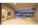 Covered patio with a backyard view featuring a pool, a custom stone waterfall, and outdoor lighting at 5103 E Juniper Ave, Scottsdale, AZ 85254