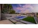 Backyard view showcases a modern pool with custom hardscape and well-manicured landscaping at 5103 E Juniper Ave, Scottsdale, AZ 85254