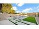Inviting pool area featuring a modern pool design and lush artificial grass at 5103 E Juniper Ave, Scottsdale, AZ 85254
