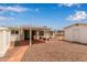 View of the backyard featuring a covered patio, a white shed, and gravel landscaping for low maintenance at 5317 E Colby St, Mesa, AZ 85205