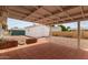 Backyard with a covered patio, a white shed, and a pathway, perfect for outdoor activities and storage at 5317 E Colby St, Mesa, AZ 85205