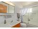 Bright bathroom with wood vanity and cabinet at 5317 E Colby St, Mesa, AZ 85205