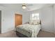 Bright bedroom with two windows, a closet, and a patterned bedspread at 5317 E Colby St, Mesa, AZ 85205