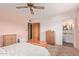 Bright bedroom featuring soft carpet, matching wood furniture, with an attached bathroom at 5317 E Colby St, Mesa, AZ 85205