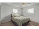 Clean bedroom featuring neutral walls and a patterned bedspread with two windows at 5317 E Colby St, Mesa, AZ 85205