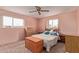 Comfortable bedroom featuring soft carpet, matching wood furniture and soft natural light at 5317 E Colby St, Mesa, AZ 85205