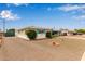 Single-story home featuring a low-maintenance front yard and a tent to cover a car at 5317 E Colby St, Mesa, AZ 85205