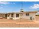 Exterior of the house showcasing a covered patio, white walls, desert landscaping, and a well-maintained yard at 5317 E Colby St, Mesa, AZ 85205
