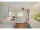 Bright kitchen featuring white cabinets, breakfast bar and laminate counters at 5317 E Colby St, Mesa, AZ 85205