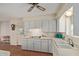 Bright kitchen featuring white cabinets, laminate counters, and ample storage space at 5317 E Colby St, Mesa, AZ 85205