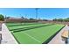 Well-maintained lawn bowling green featuring manicured grass and comfortable seating for spectators at 5317 E Colby St, Mesa, AZ 85205