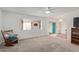 Cozy living room with ceiling fan, carpet, and lots of natural light at 5317 E Colby St, Mesa, AZ 85205