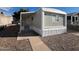 Charming single-story home featuring a covered porch and gravel landscaping at 535 S Alma School Rd # 37, Mesa, AZ 85210