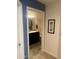 Hallway view into a clean bathroom featuring modern fixtures and neutral color palette at 5350 E Deer Valley Dr # 3267, Phoenix, AZ 85054